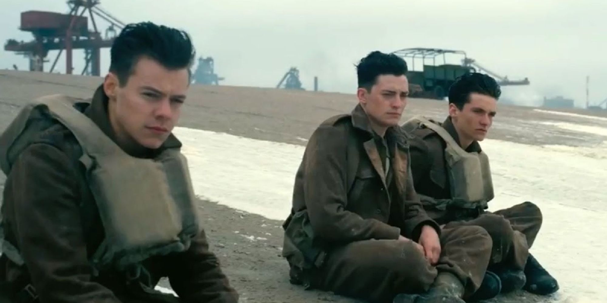 Harry Styles sitting on a beach in Dunkirk