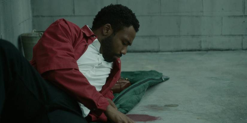 Donald Glover as Earn looking at blood stain in Atlanta