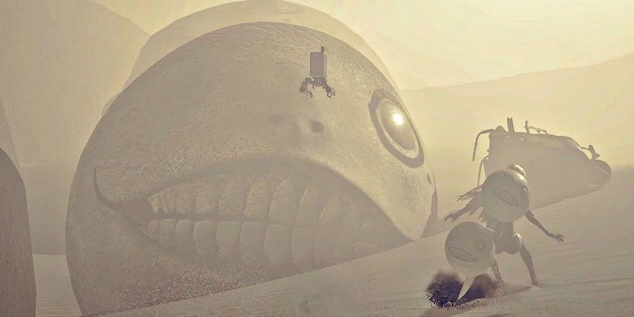 A player fighting the boss Emil in the desert of Nier: Automata