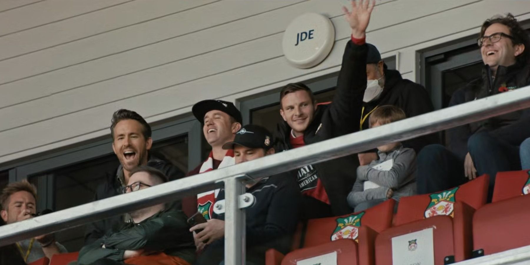 Ryan Reynolds, Rob McElhenney and Paul Mullin in Wrexham stands