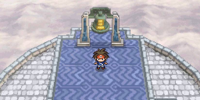 A male trainer standing near the bell at the top of Celestial Tower in Black 2 & White 2