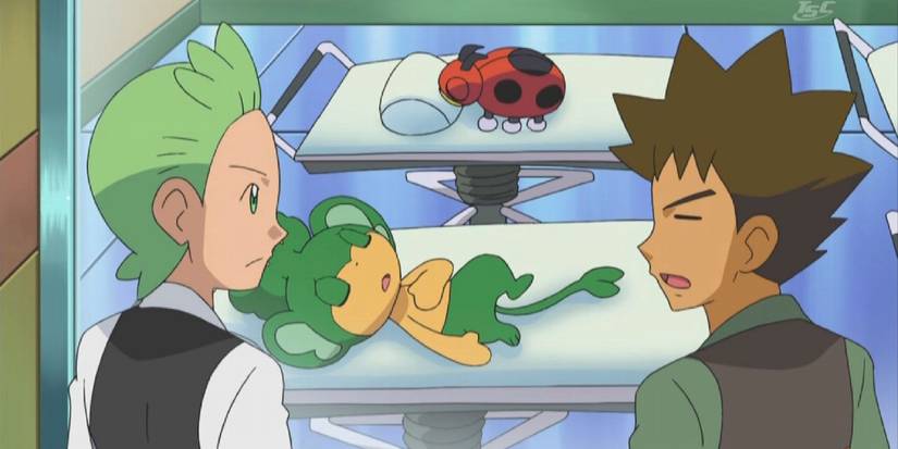 Cilan and Brock standing over Pansage in a Pokemon Center