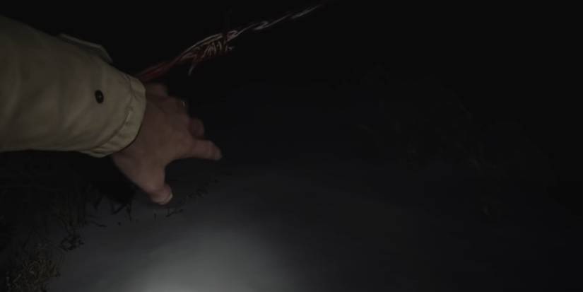 Resident Evil Village Going Underneath A Barbed Wire Fence