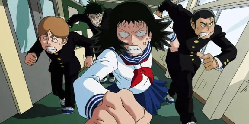 3 young men and a young woman in school unifroms march angrily down a school hallway