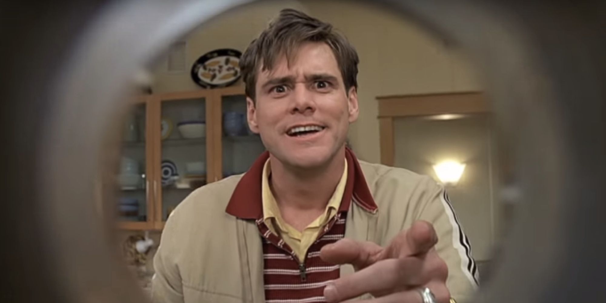 Jim Carrey pointing his finger at a camera lens in The Truman Show