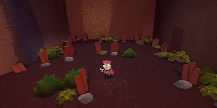 A screenshot of Tinykin's Milo in a mini graveyard