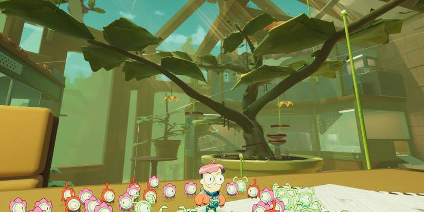 Milo looking at a tree arching over the greenhouse in Tinykin 