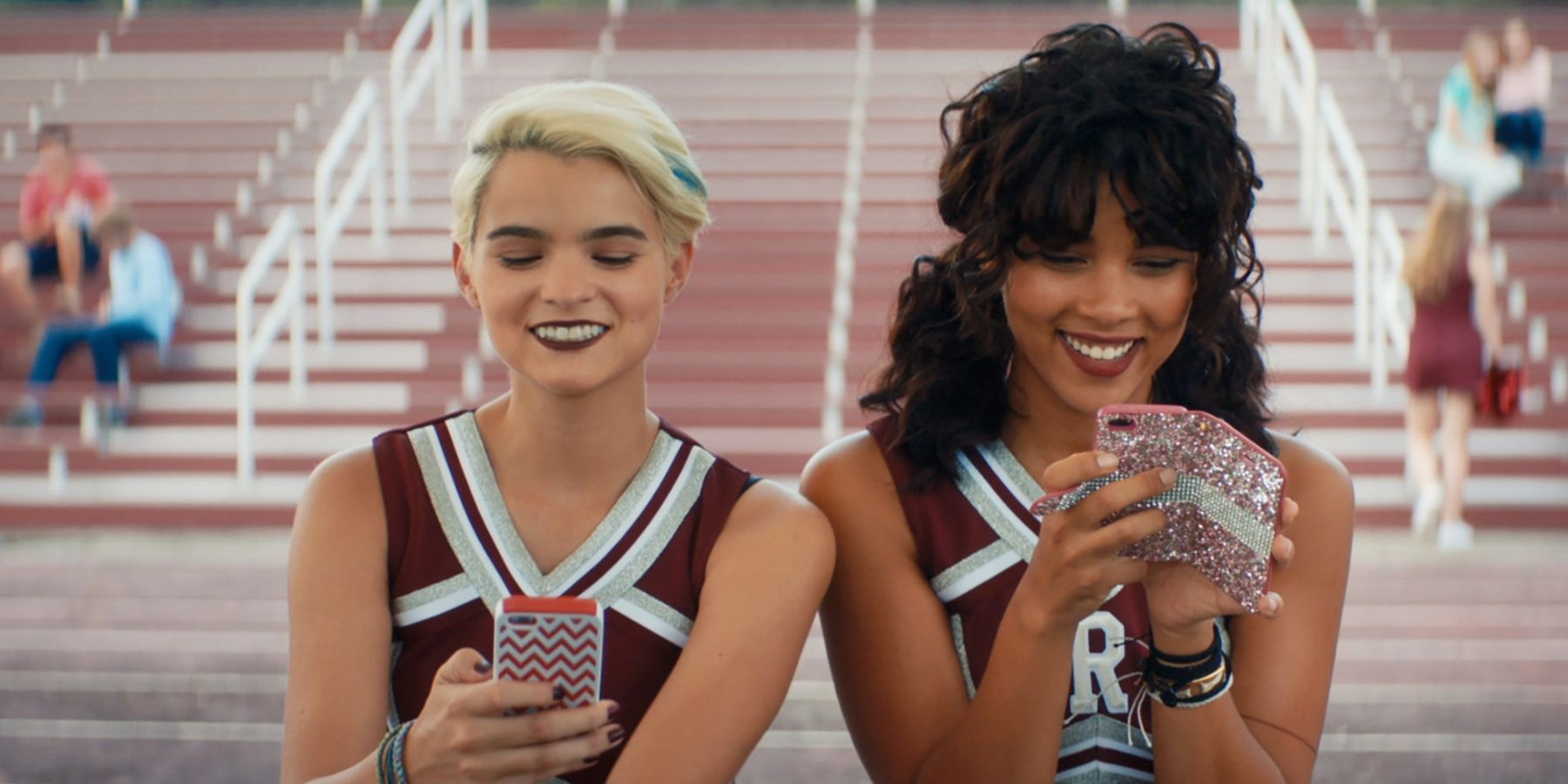 McKayla and Sadie sitting in their cheerleading uniforms in Tragedy Girls