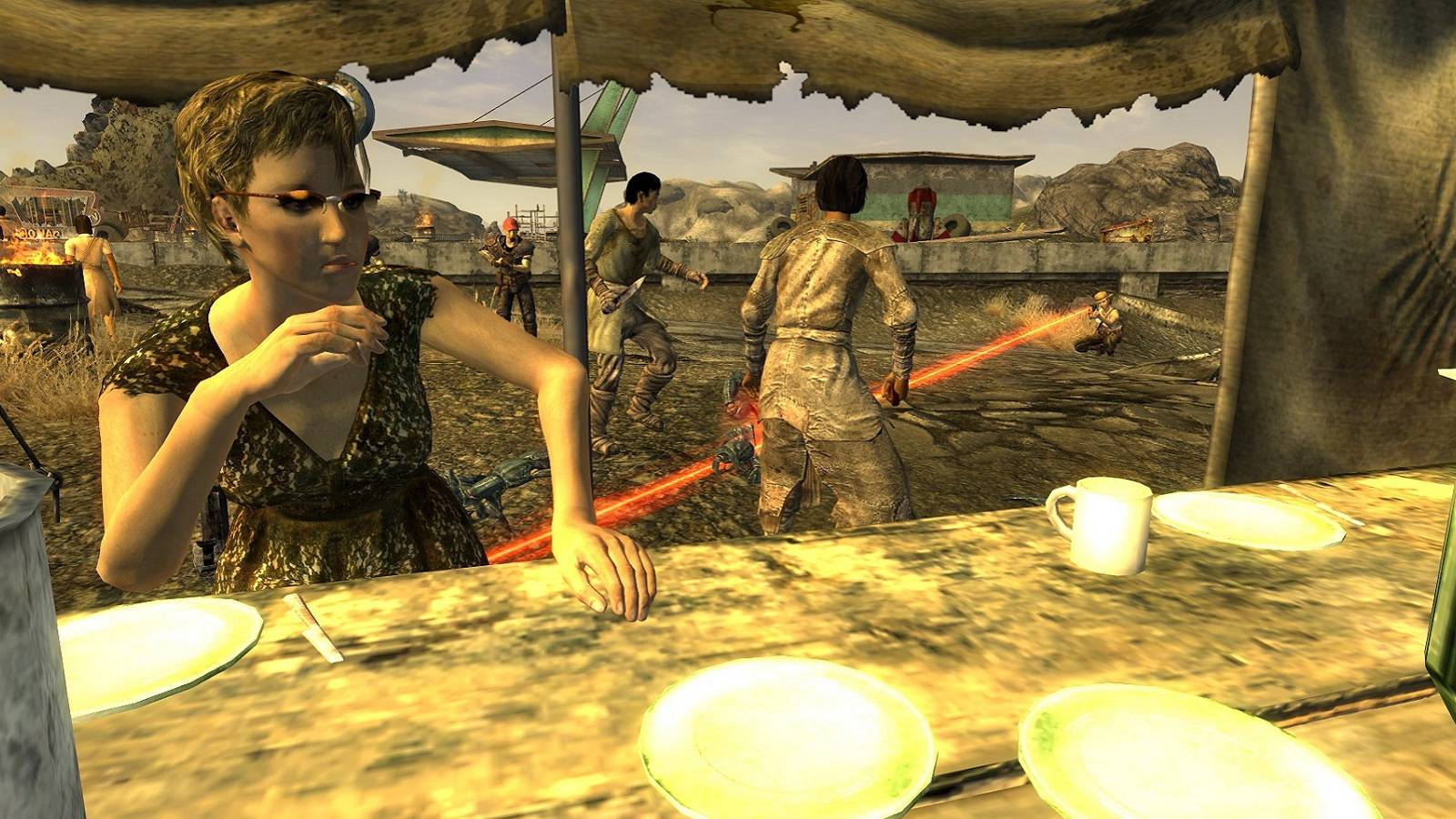 Image from Fallout: New Vegas showing a settlement that's under attack.