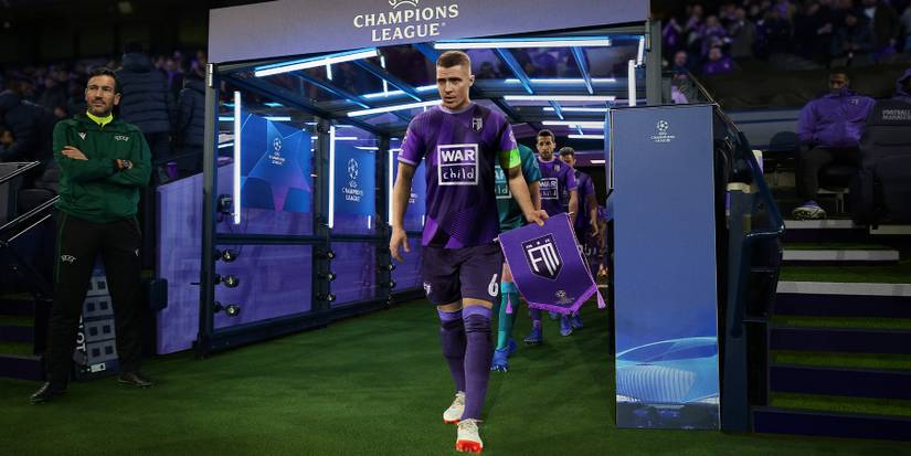 Official Football Manager 2023 art showing a player walking onto the pitch ahead of a UEFA Champions League match.