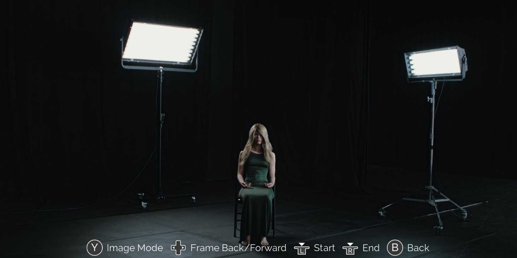 Marissa Marcel sitting in a chair surrounded by spotlights in Immortality