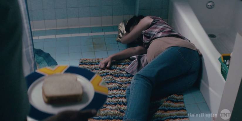 A pregnant Julia laying on bathroom floor in Animal Kingdom series finale