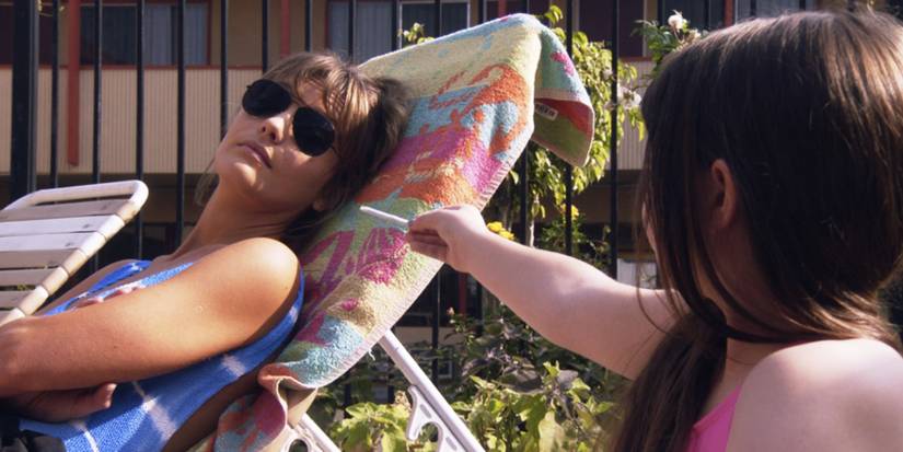 Julia (Scarlett Abinante) hands Smurf (Leila George) a cigarette in Animal Kingdom