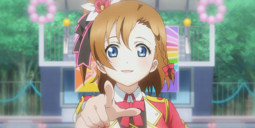 Honoka Kousaka, a Love Live character, pointing towards the camera enthusiastically.