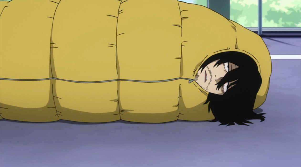 Aizawa lying in his sleeping bag at school.