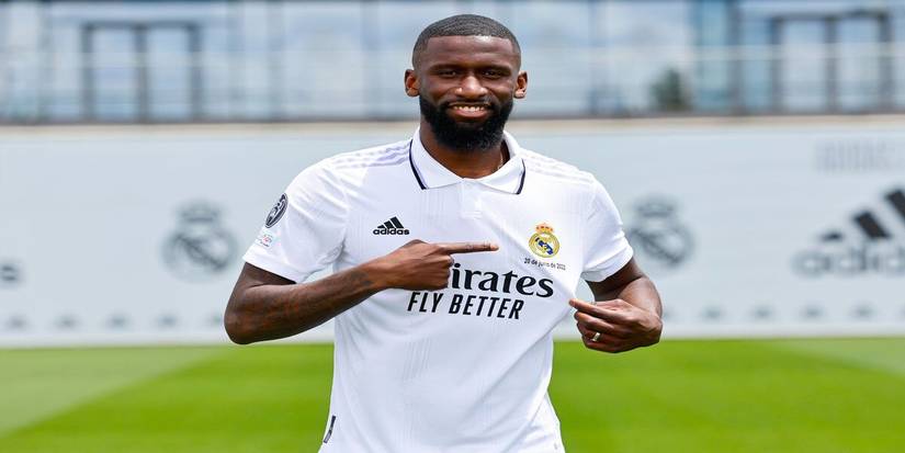 rudiger pointing to Real Madrid badge