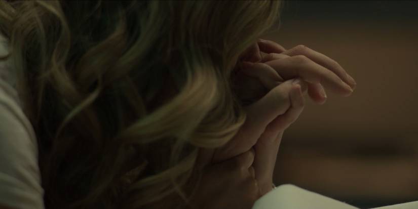 Sam cradles Charlie's hand in American Horror Stories "Necro"