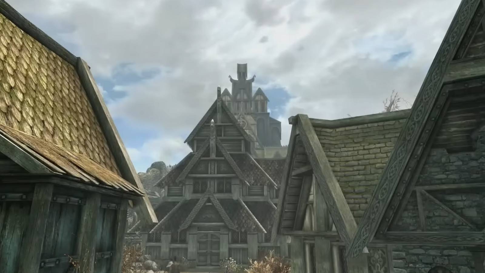 Image from Skyrim showing some of the houses in Whiterun and Dragonsreach off in the distance.