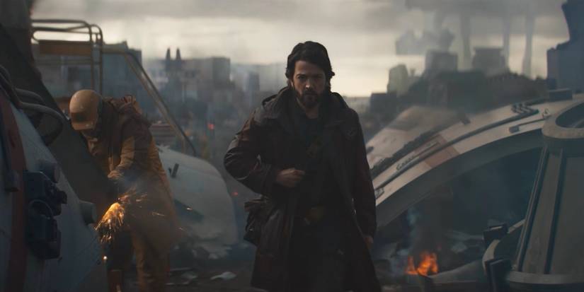 cassian andor walking through a scrap yard