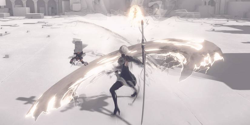 2B utilizing melee and ranged attacks against Adam in Nier Automata.