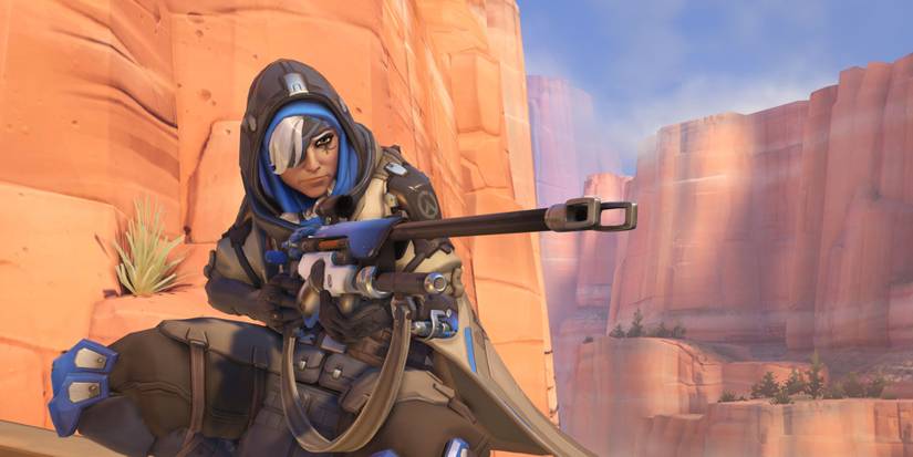 Ana Amari from Overwatch pointing her Biotic Rifle
