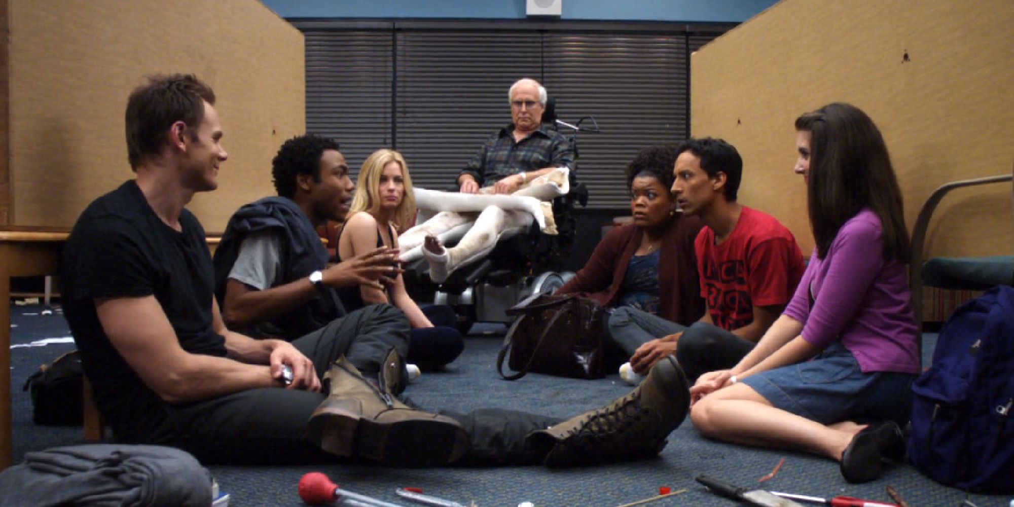Jeff, Troy, Britta, Pierce, Shirley, Abed, and Annie sitting in a trashed study room