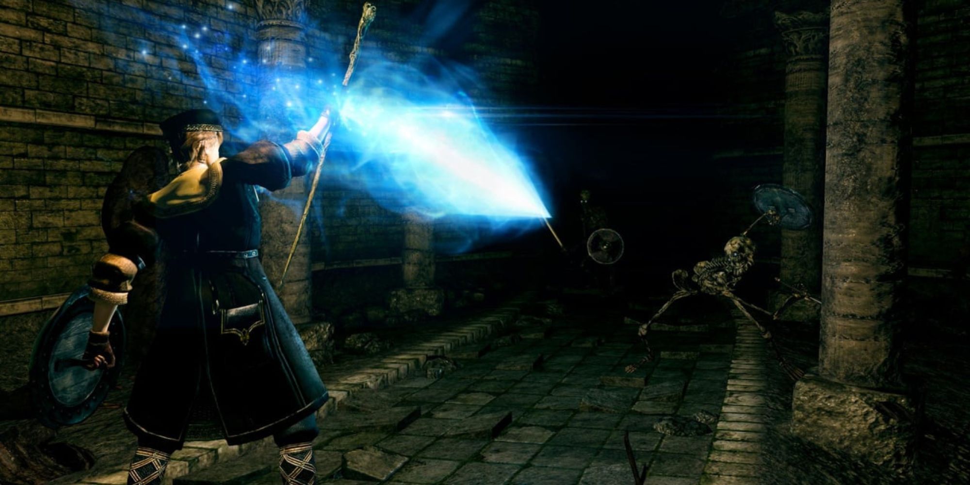 A player casting a spell at skeletons down a dark tunnel in Dark Souls