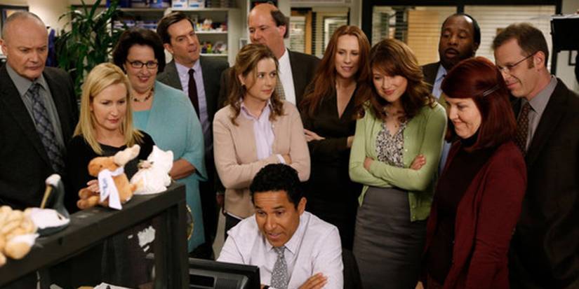 Everyone gathers around Oscar's computer in The Office