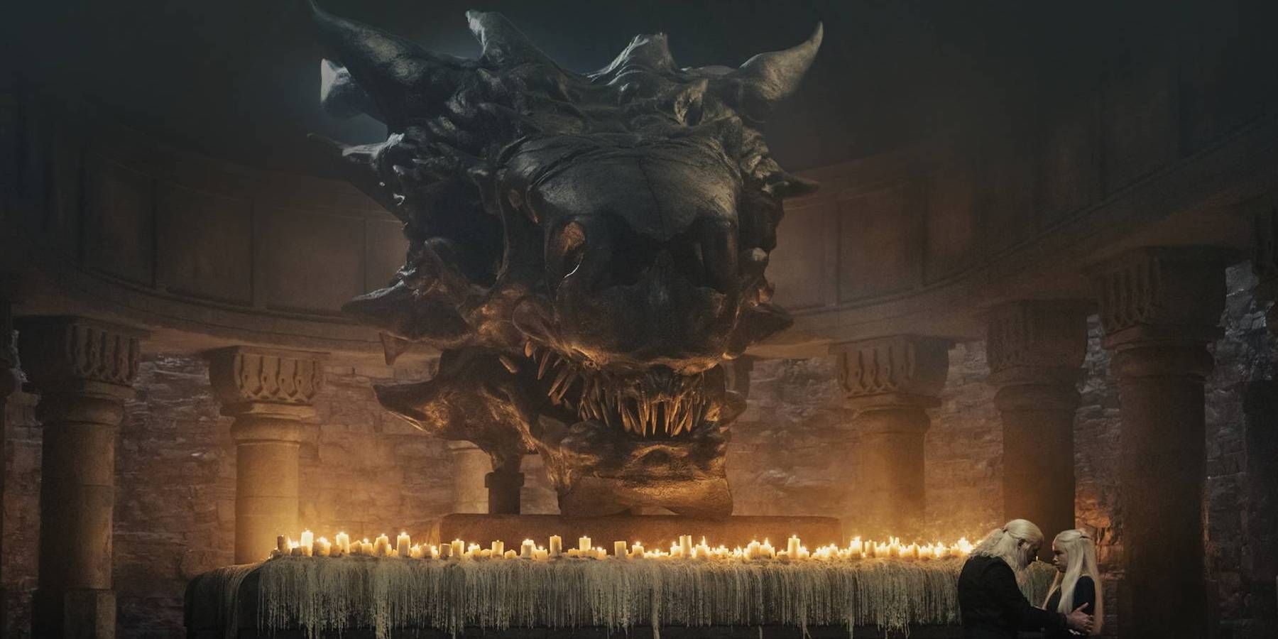 Viserys and Rhaenyra stand in front of Balerion's skull in House of the Dragon.