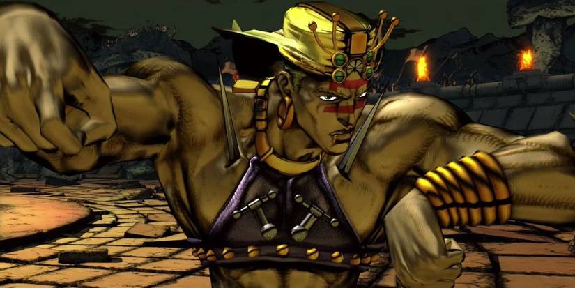 Screenshot of Wamuu Jojo All Star Battle R. A muscular, scantily dressed man wearing plenty of jewellery, and with two daggers pierced through his chest