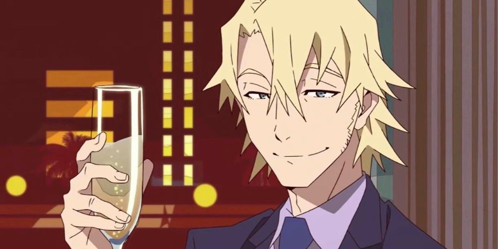 A handsome blonde man smiling at the screen with a champagne glass in his hand
