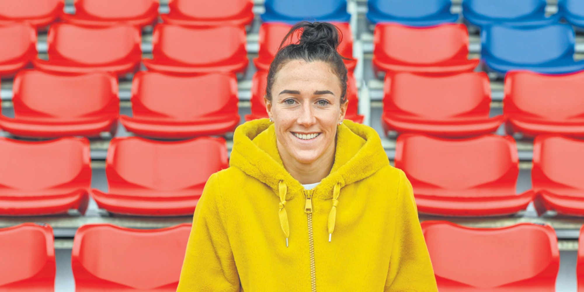 Lucy Bronze sitting in the stands smiling