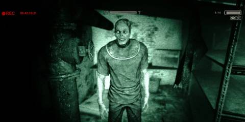 An Outlast prisoner filmed through the night vision lens of a video camera