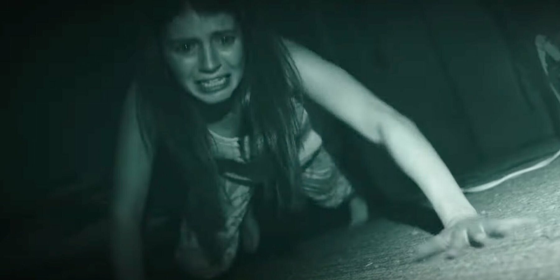 Emily Bader looking scared in Paranormal Activity_ Next Of Kin