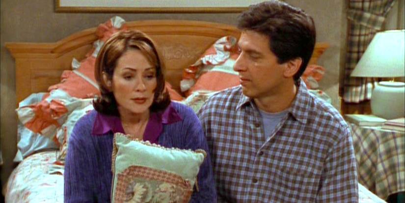 Ray and Debra sit on their bed in Everybody Loves Raymond