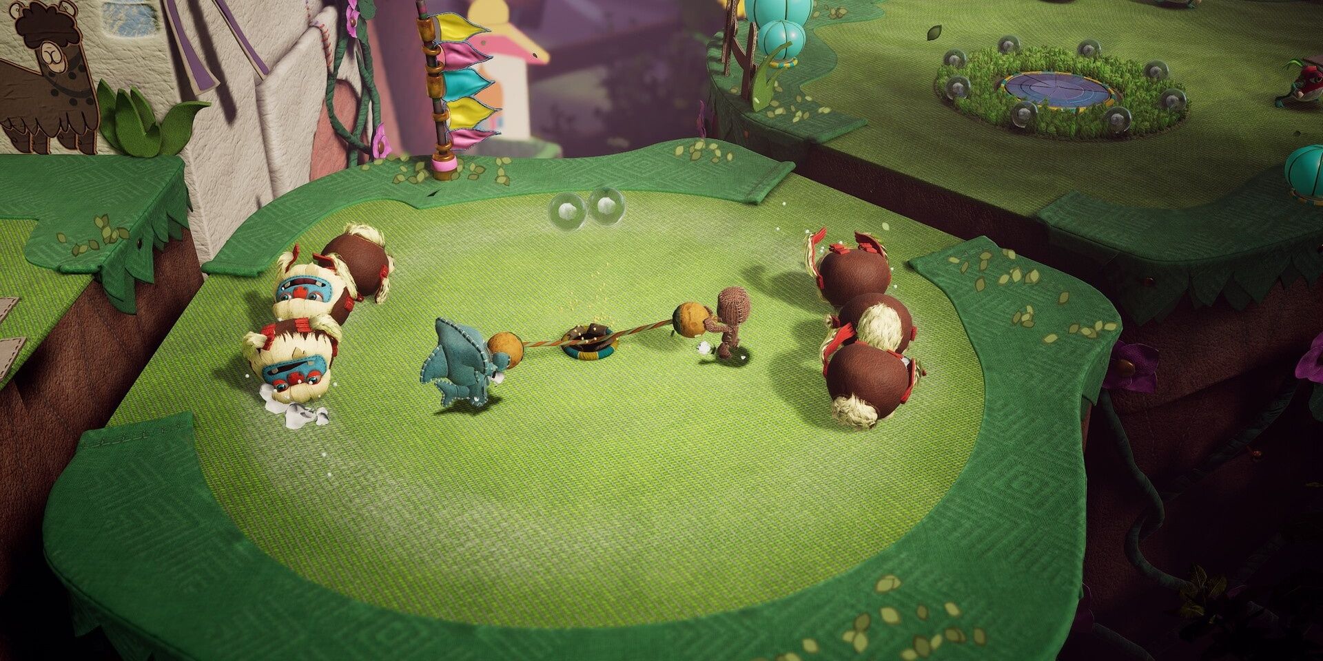 Two Sackboy players tugging at something in the ground in Sackboy: A Big Adventure