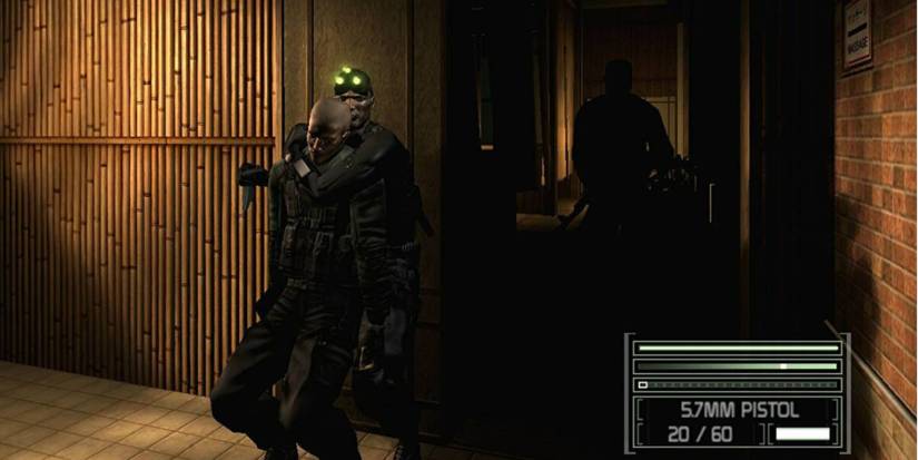 Sam fisher stealthily choking out a guard as another approaches in Splinter Cell Chaos Theory