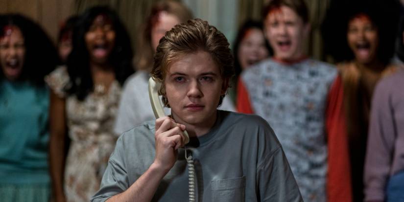 Kevin from The Midnight Club talking on the phone with actors behind him