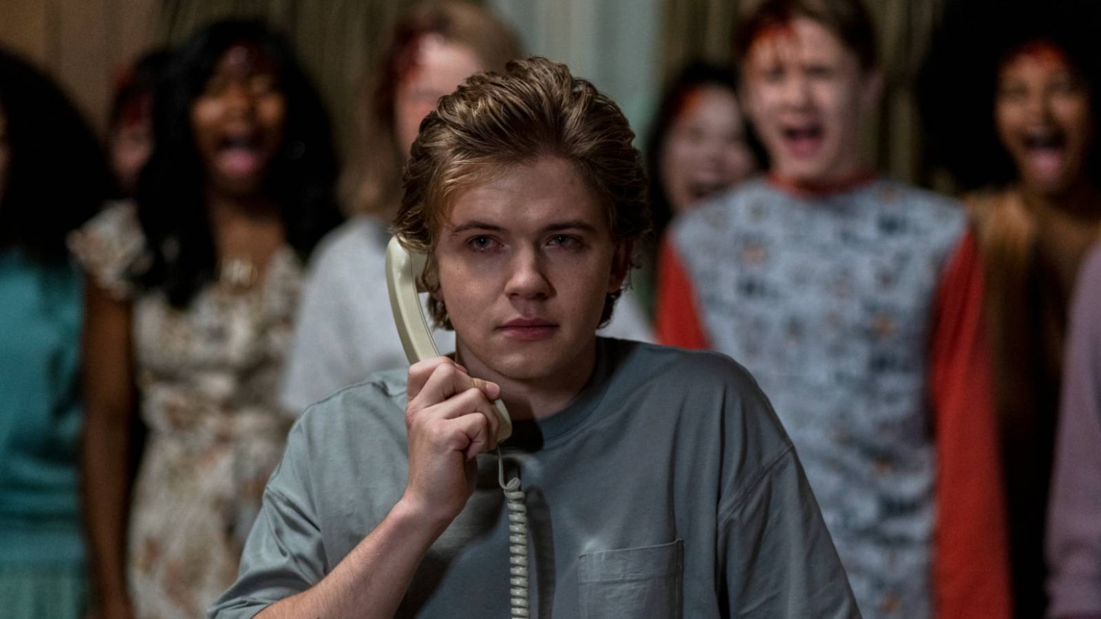 Kevin from The Midnight Club talking on the phone with actors behind him