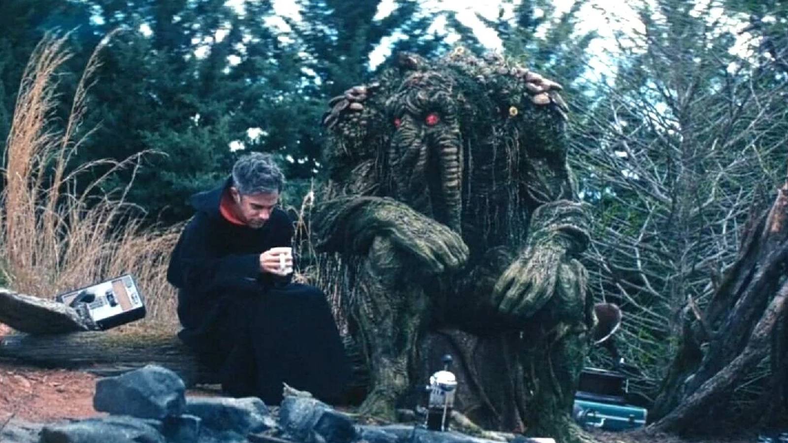 Jack and Ted sitting by a campfire at the end of Werewolf by Night