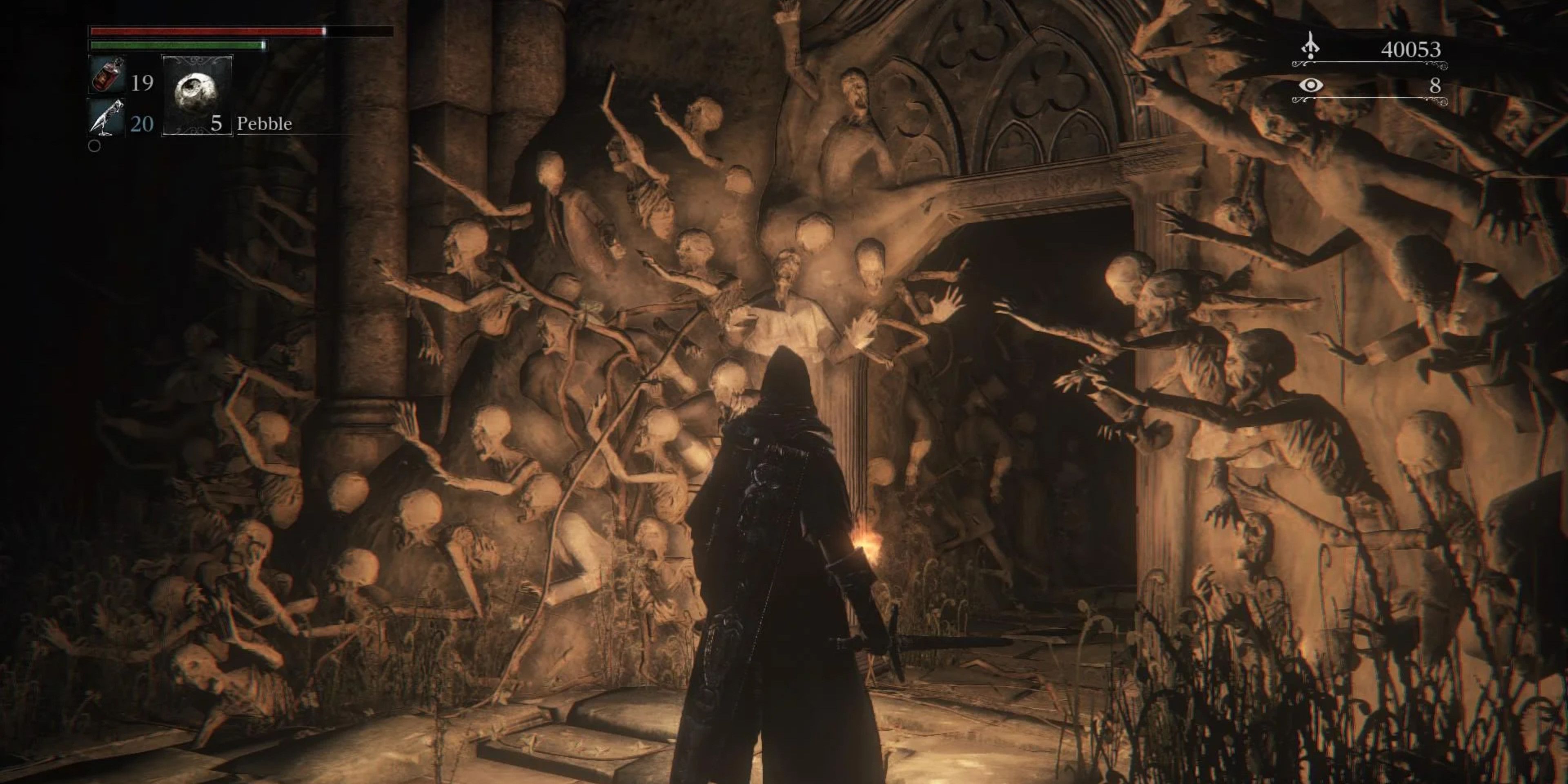 Player character facing the entrance into the Cathedral in Yahar'gul in Bloodborne. The corpses of the city's residents are plastered onto the wall