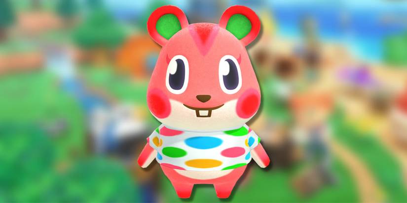 Apple, a pink and green hamster with a polka dot shirt, on a blurred green background.