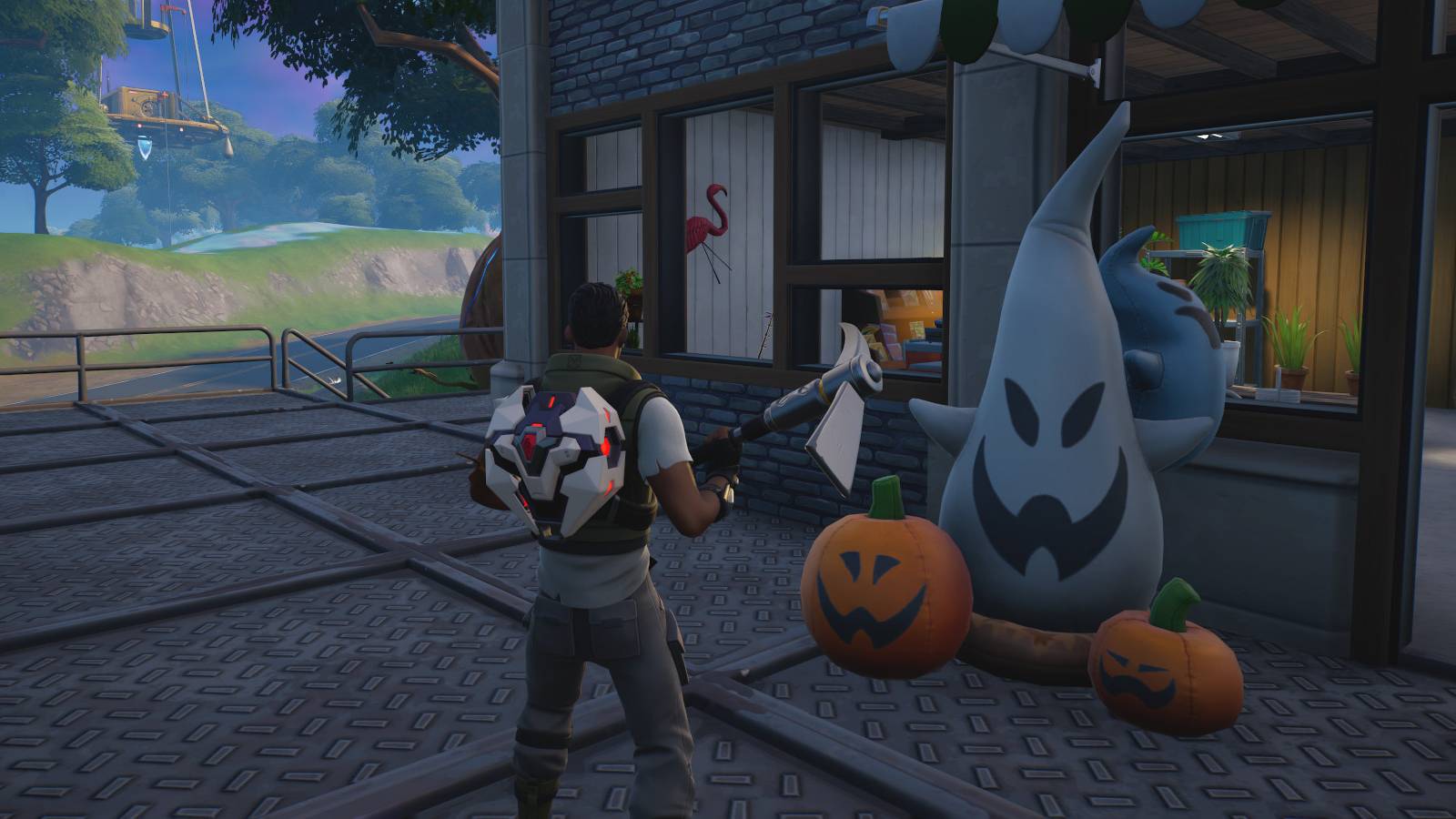 A Fortnite player facing a building while holding a pickaxe