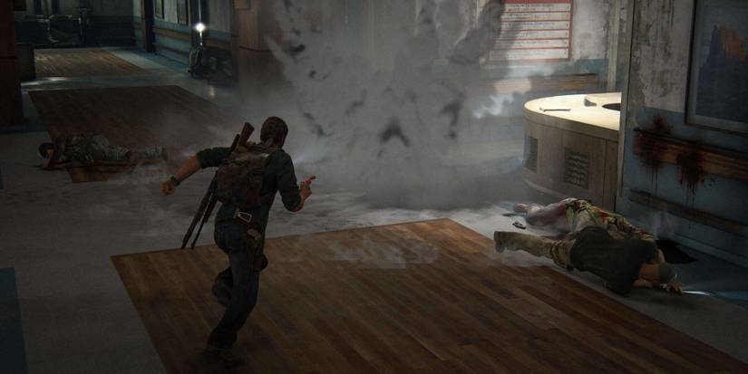 Joel throwing a smoke bomb in the Firefly Hospital in The Last of Us Part 1