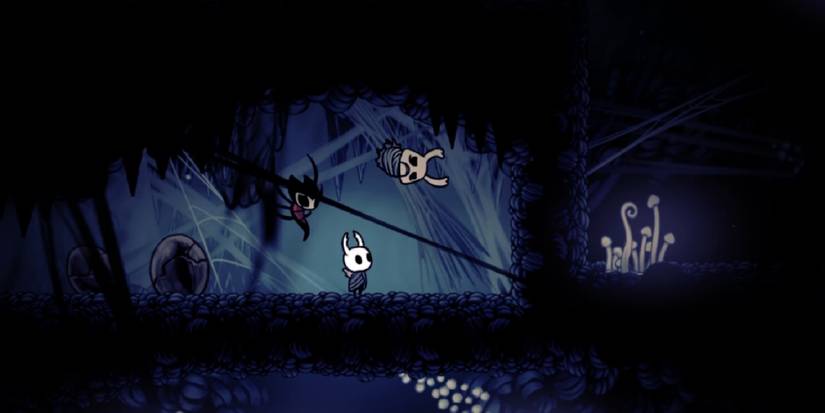 The Knight looking up at a tied-up Zote.