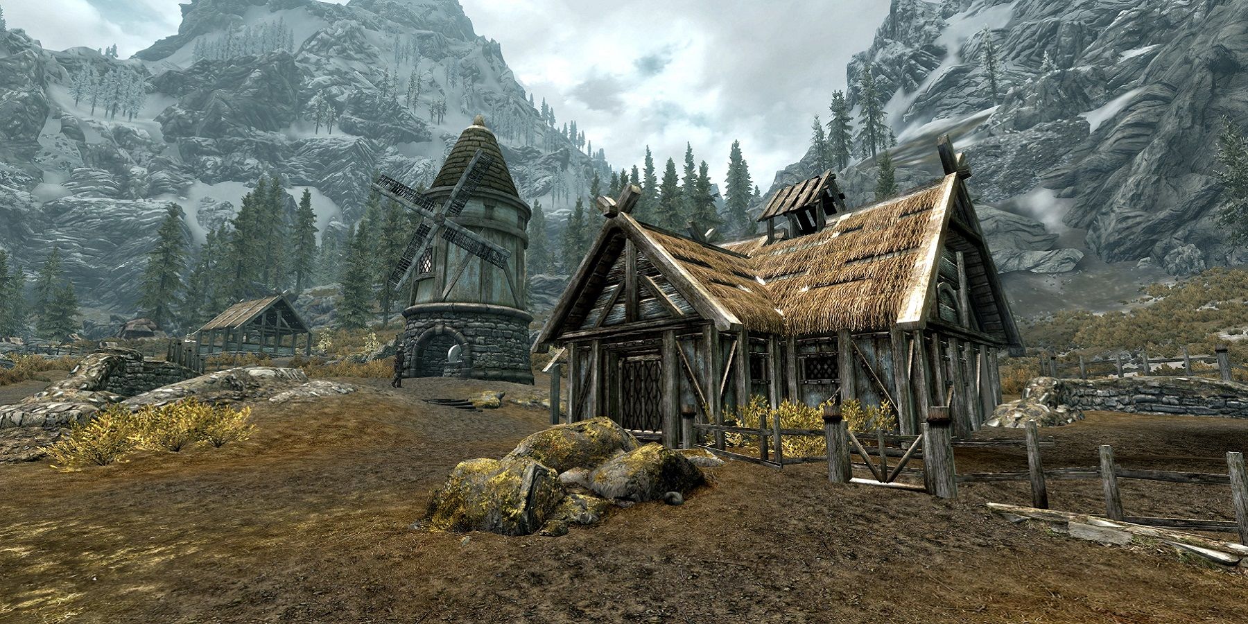 Screenshot from Skyrim showing Pelagia Farm with the snow-covered mountains in the background.