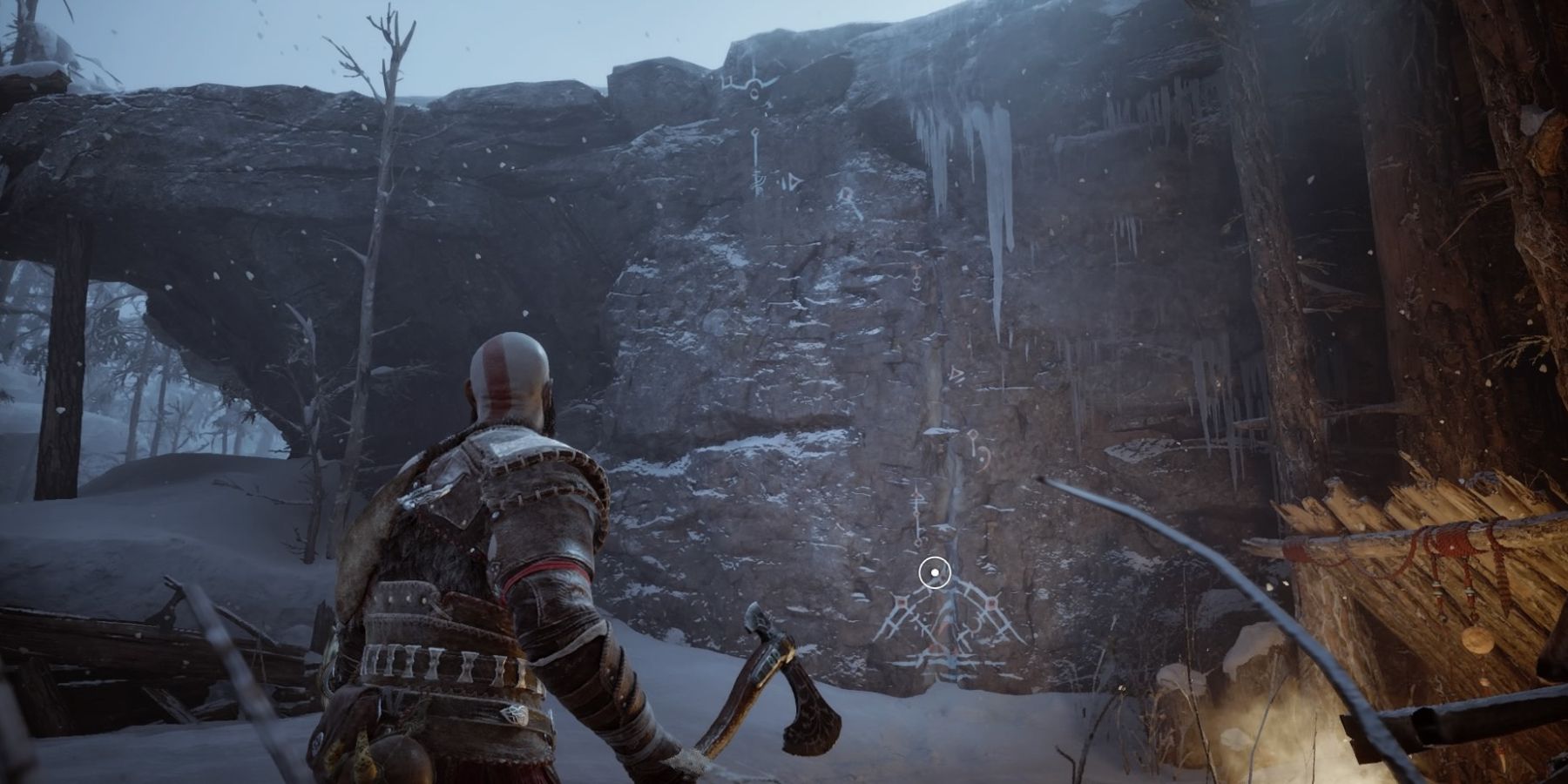 Kratos prepares to climb a cliff in God of War: Ragnarok