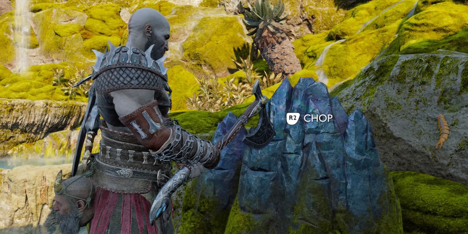 Kratos chops a block of ore in God of War Ragnarok