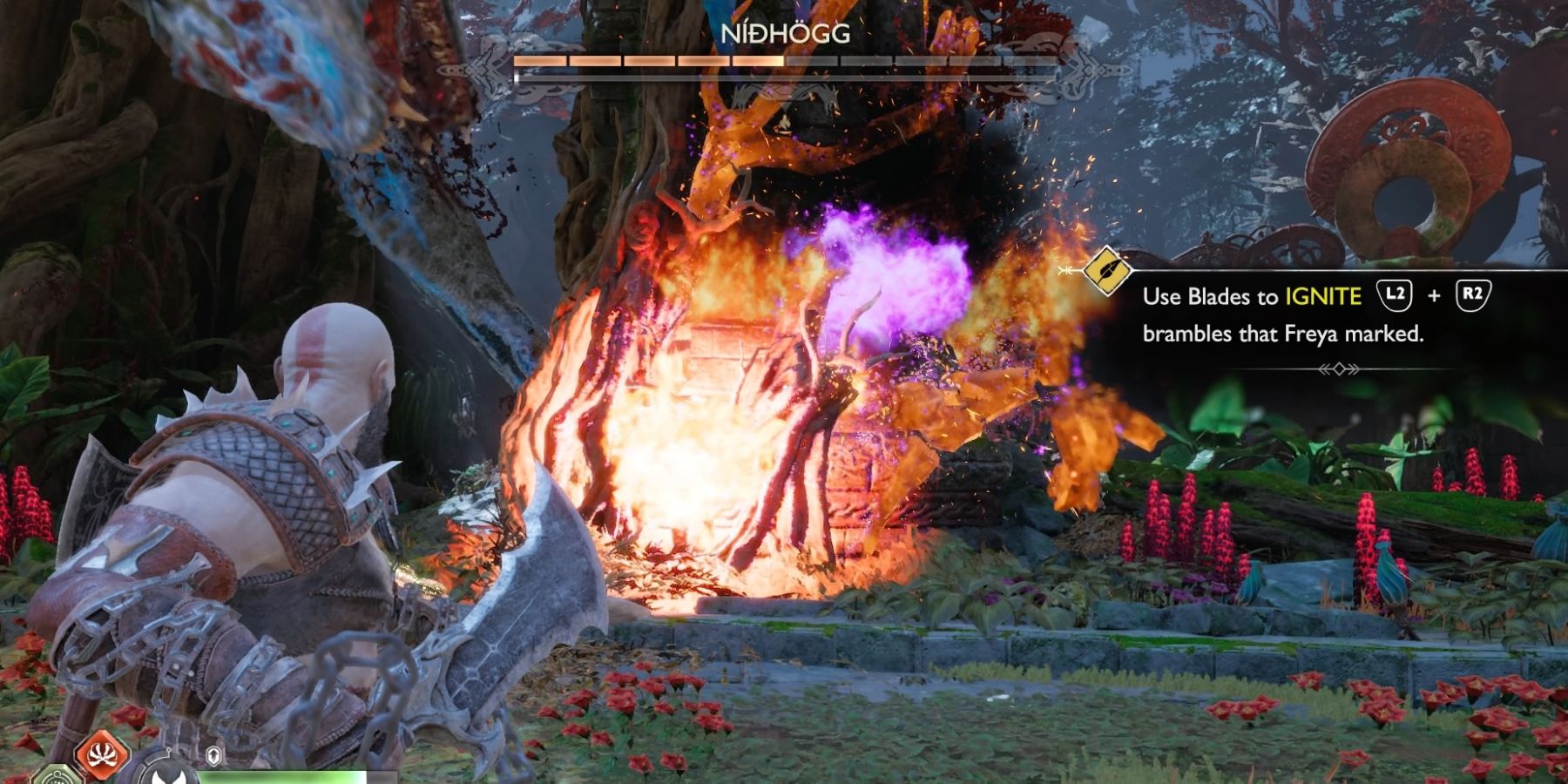 Kratos burns Nidhogg from a tree in God of War Ragnarok