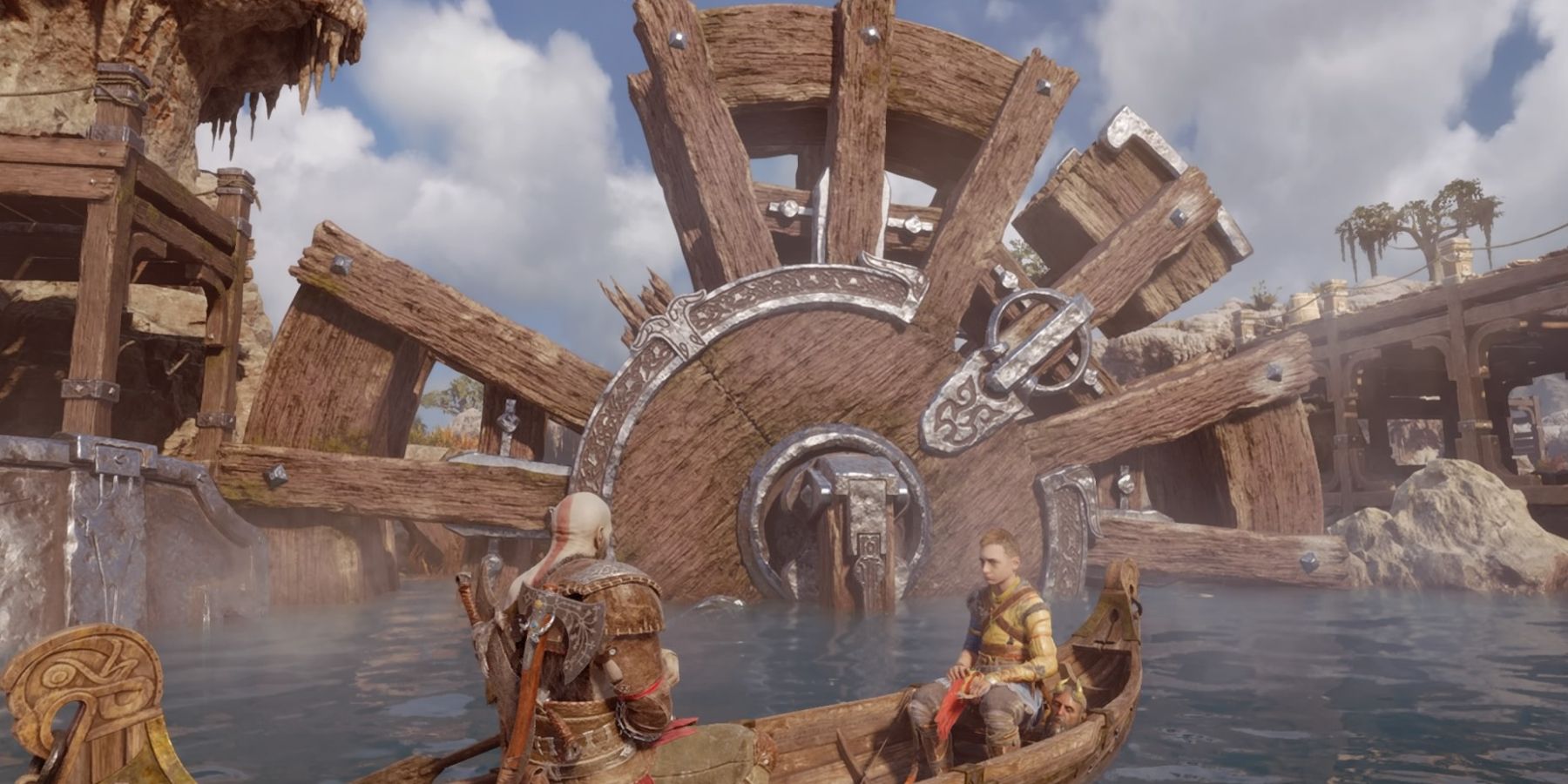 Kratos and Atreus face a giant water wheel in God of War Ragnarok